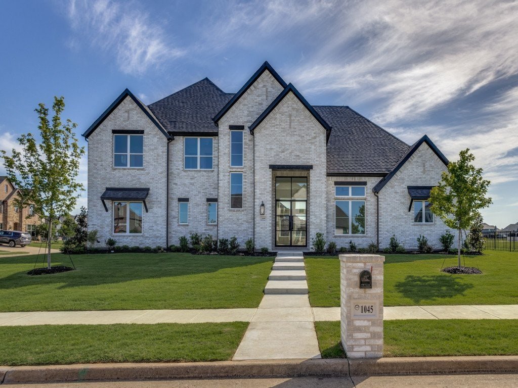 White brick front exterior of a Gutman custom home in Gunter, Texas