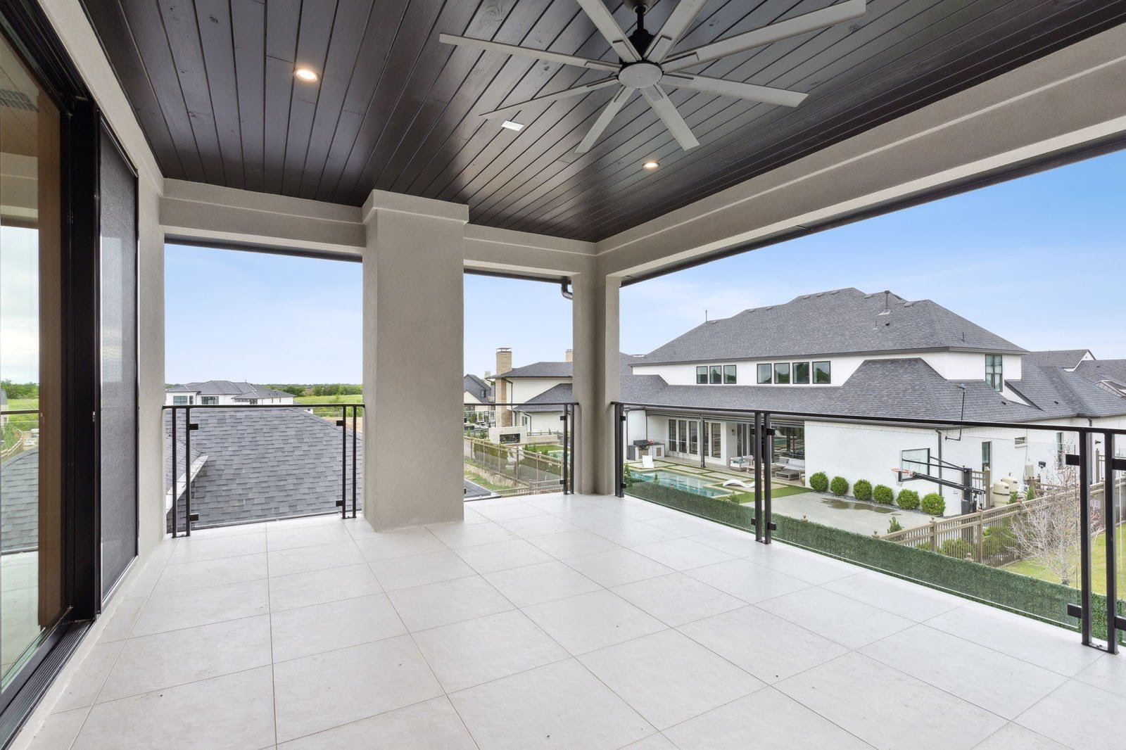 Covered second-story balcony at Chambord Custom Home I