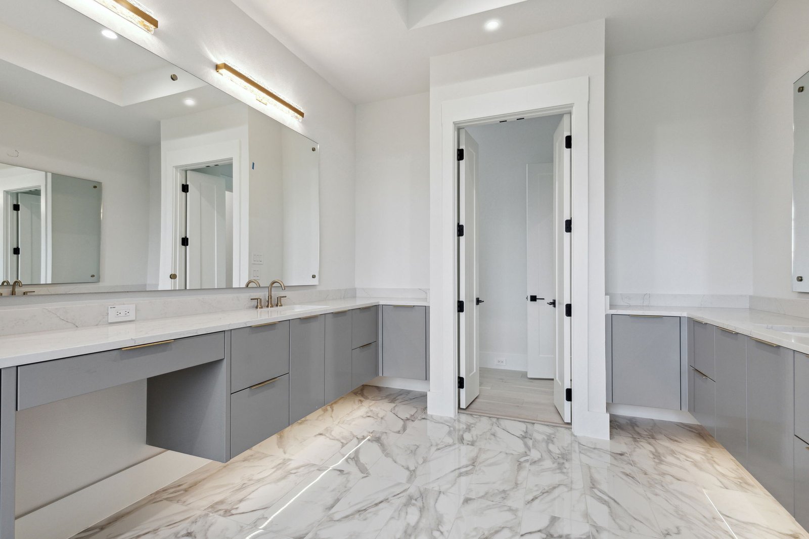 Primary bathroom with dual vanities at Chambord Custom Home I