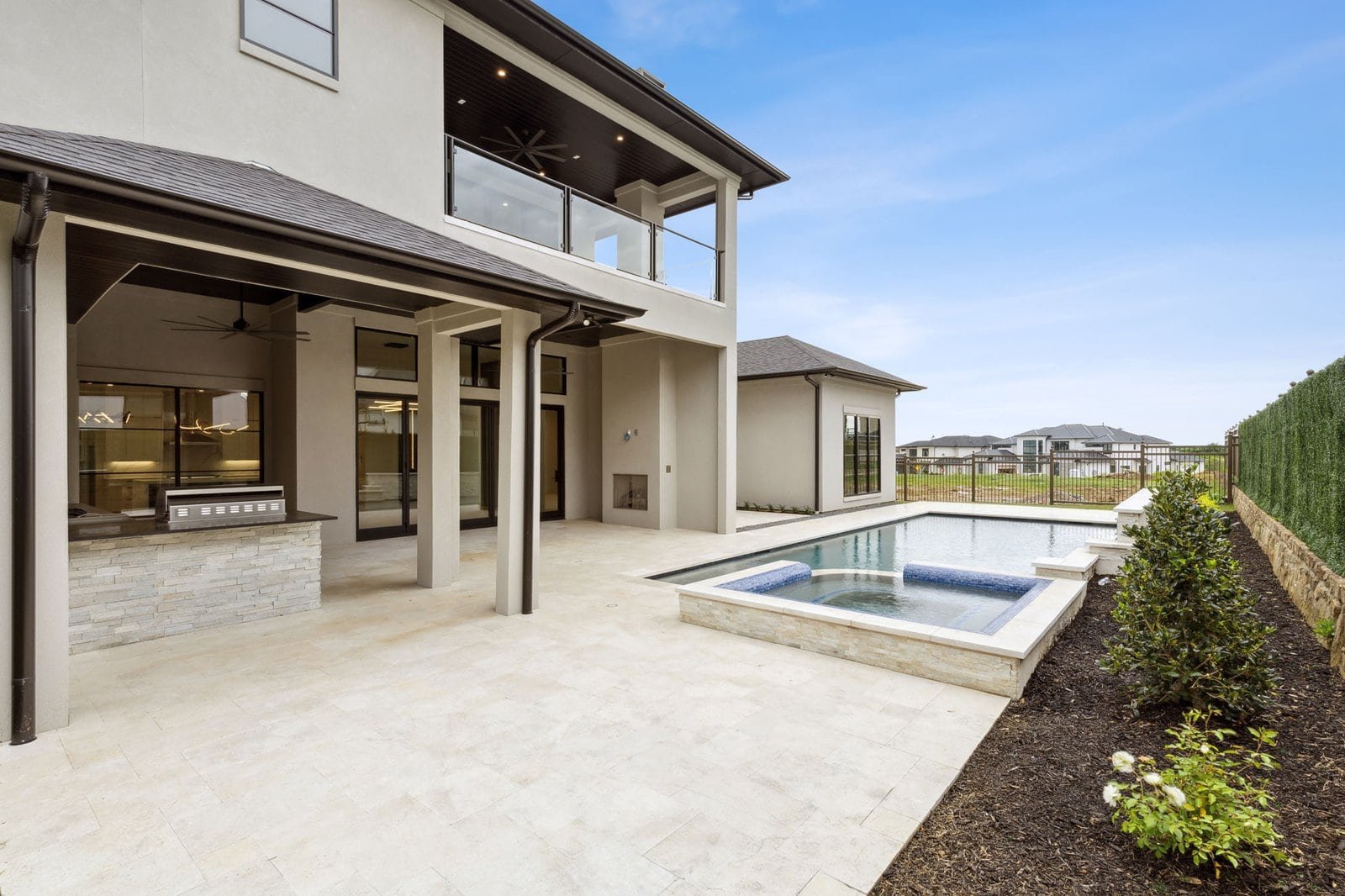 Rear exterior, covered patio and pool at Chambord Custom Home I in The Hills of Kingswood