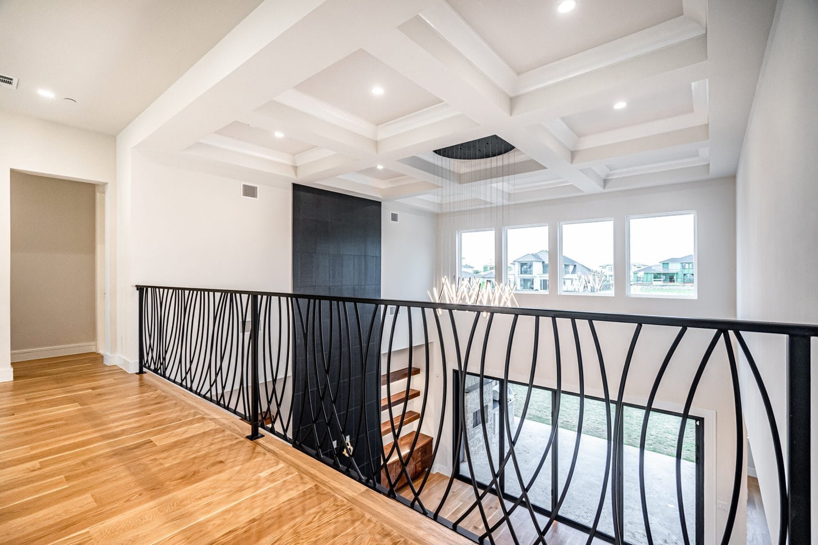Second-floor landing with custom railing at Chambord Custom Home II