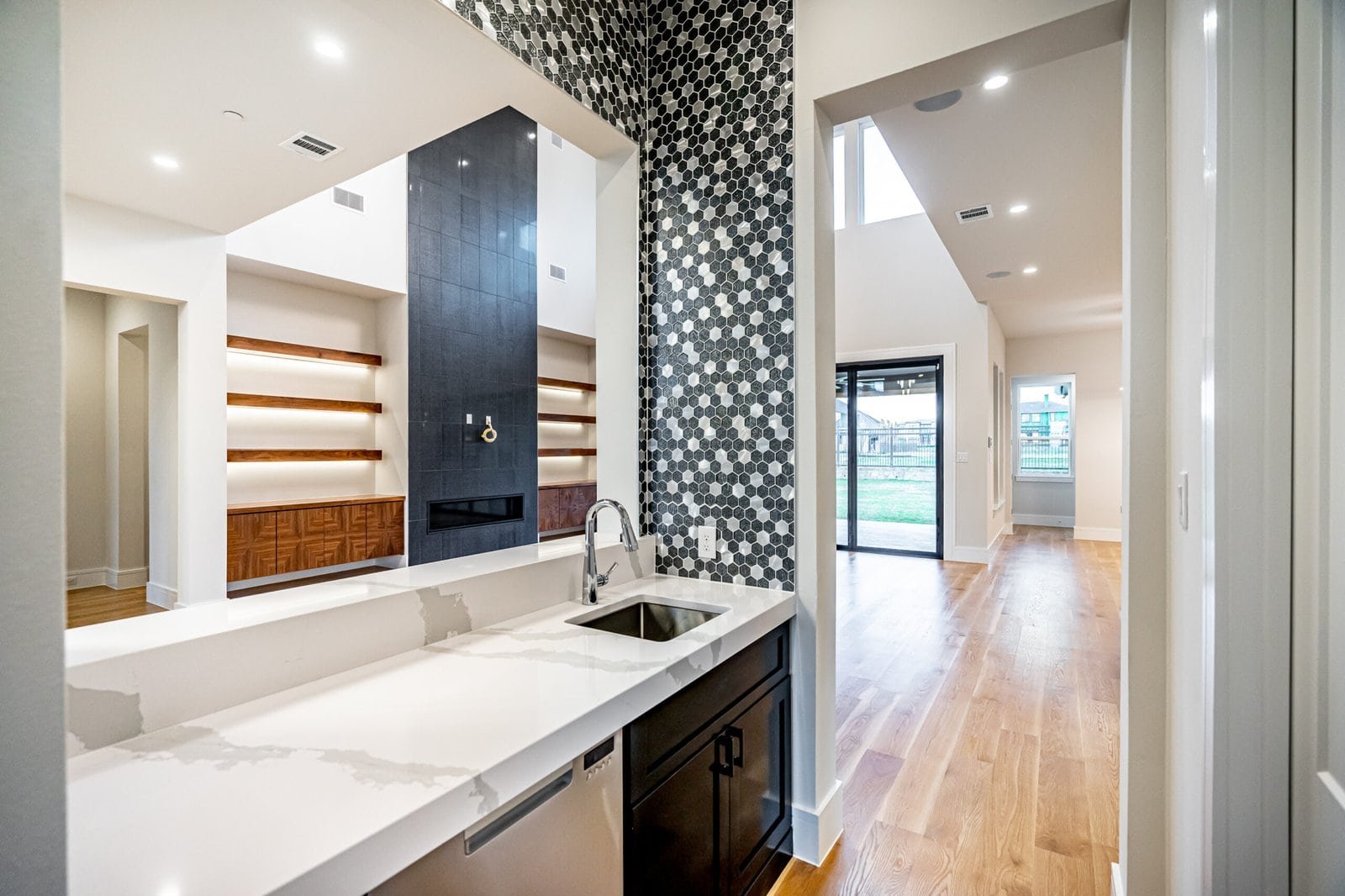 Custom wet bar connecting indoor and outdoor living at Chambord Custom Home II