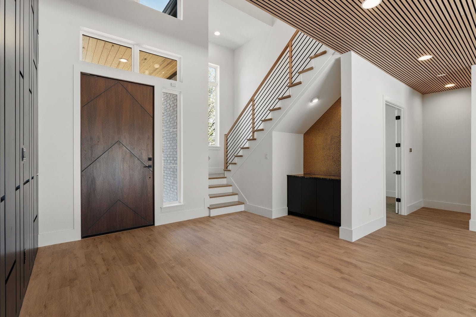 Light-filled entry and modern staircase in a Melissa custom home