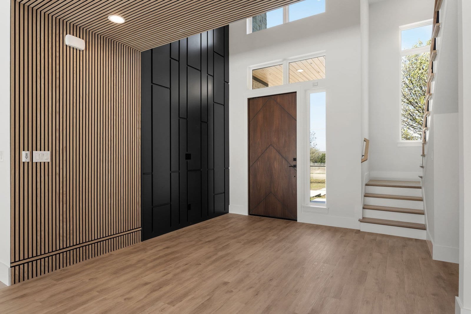 Custom foyer with a wood-slat feature wall in a Melissa home