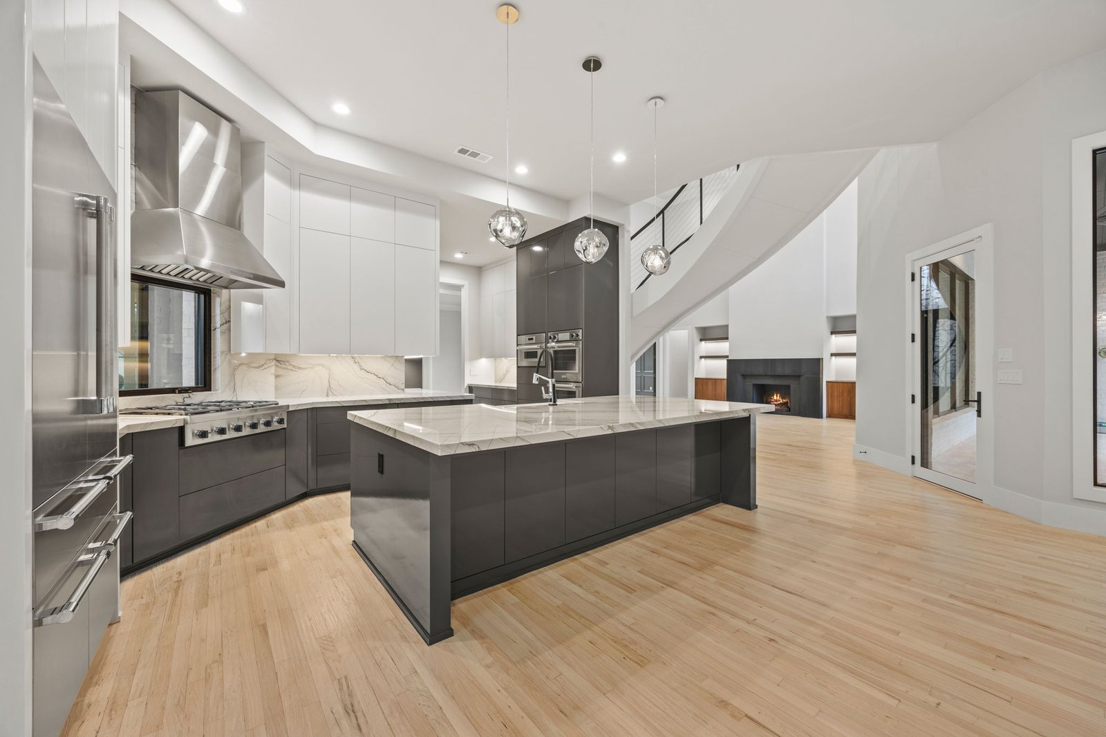 Renovated West Plano kitchen with a large island, contrasting cabinetry and stainless-steel appliances